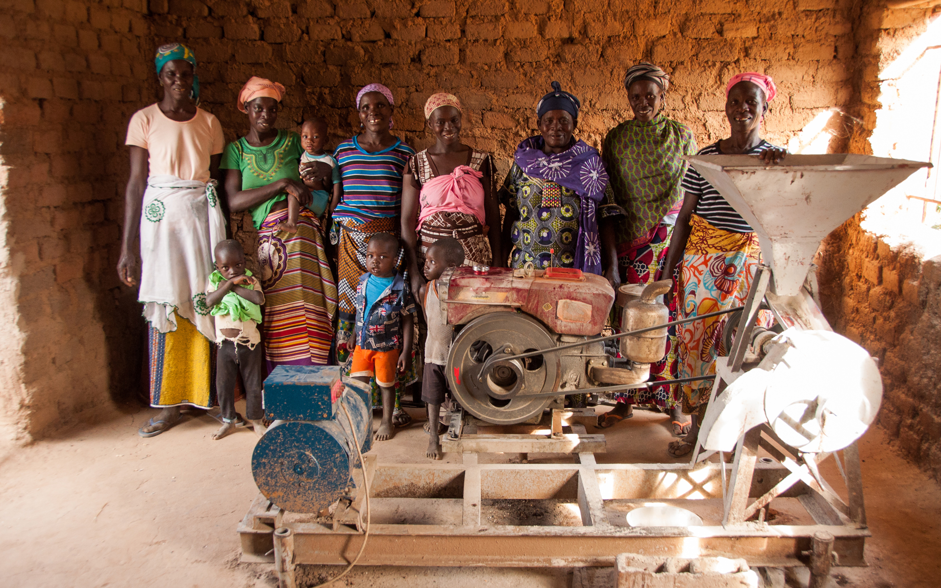 Women on a Tree Aid project in Mali standing with shea processing equipment that they received through the project.