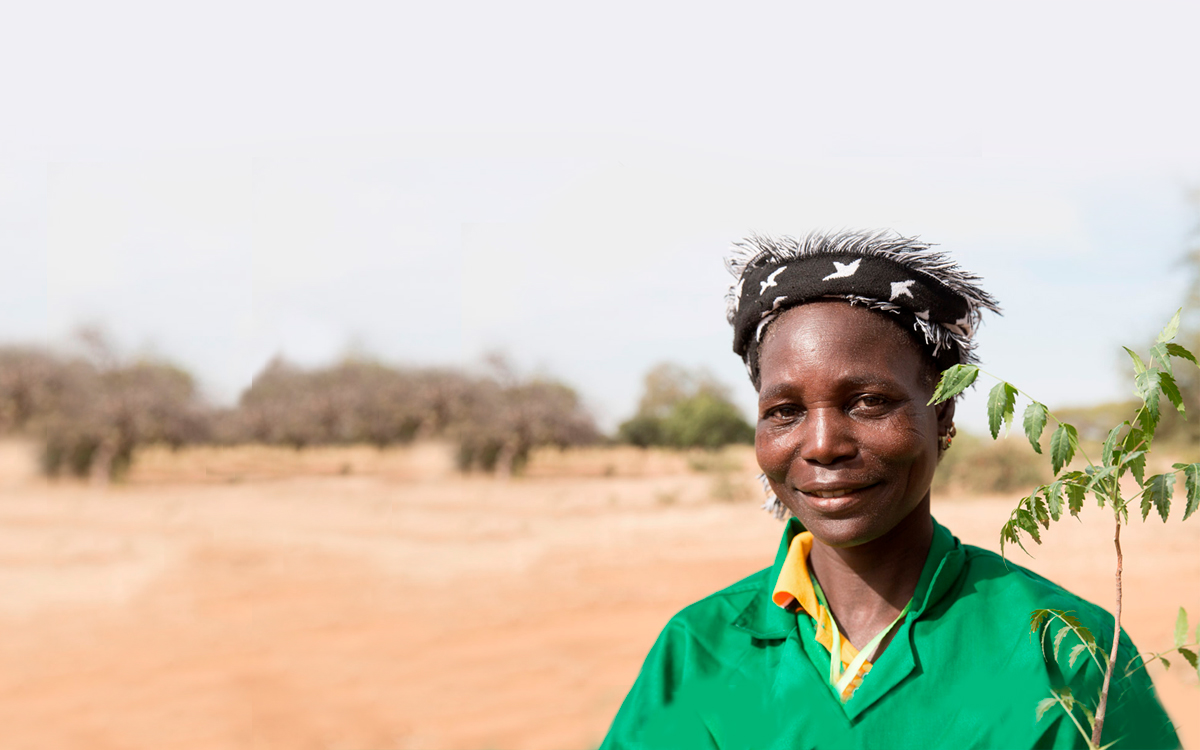 Clsoe up of Somowaga, a forest guard in Burkina Faso, holding a tree sapling.