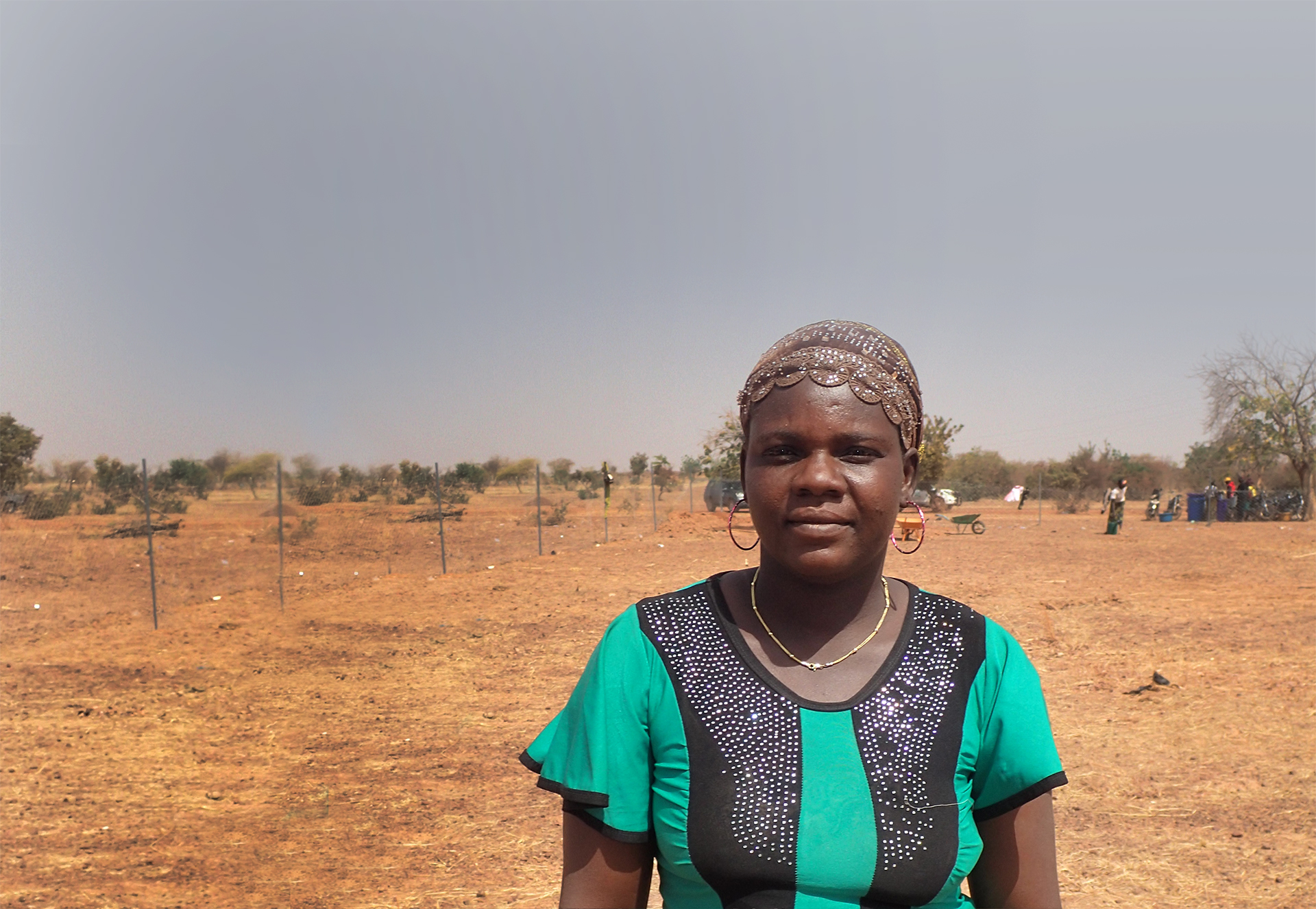 Fatimata, a woman in Burkina Faso, stood in front of a degraded landscape.