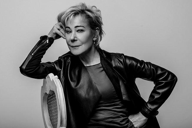 Zoë Wanamaker, Tree Aid patron, credit Idil Sukan, sat on a chair in black and white