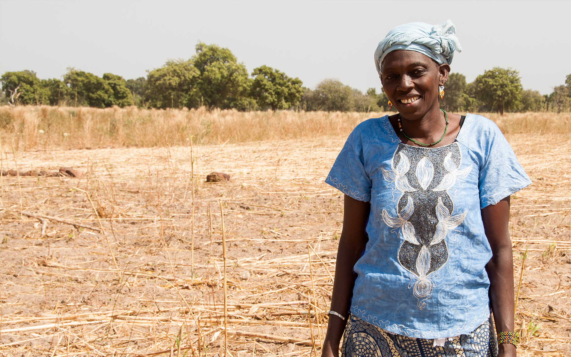 Setou, a member of Tree Aid's She Grows project, stood on degraded land in her community.