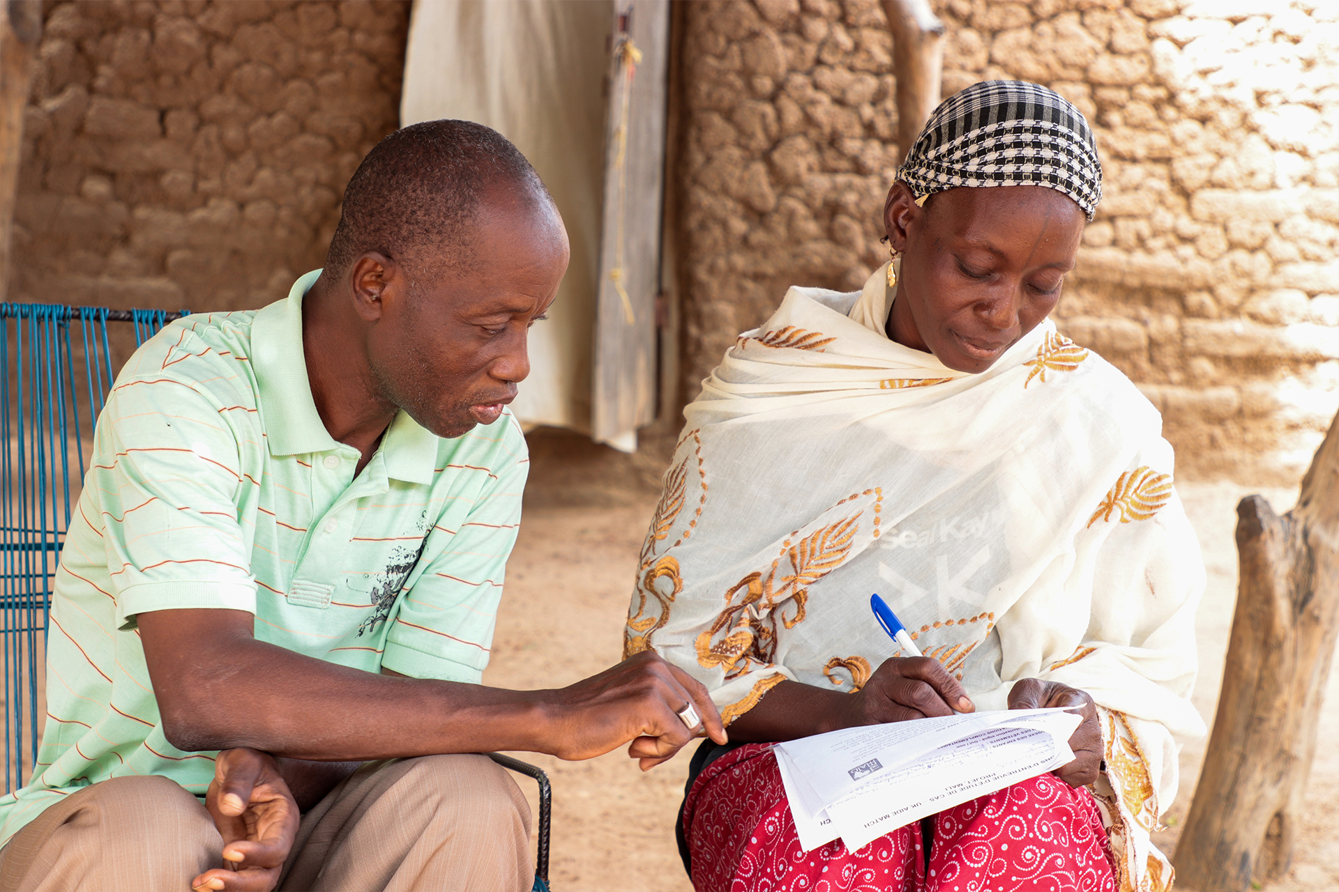 Djamako, a woman on Tree Aid's She Grows project, talking with a project admin member.